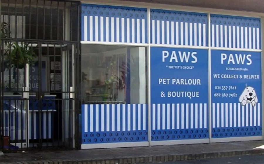 The blue and white striped Paws Pet Parlour & Boutique shopfront at Sea Breeze Centre
